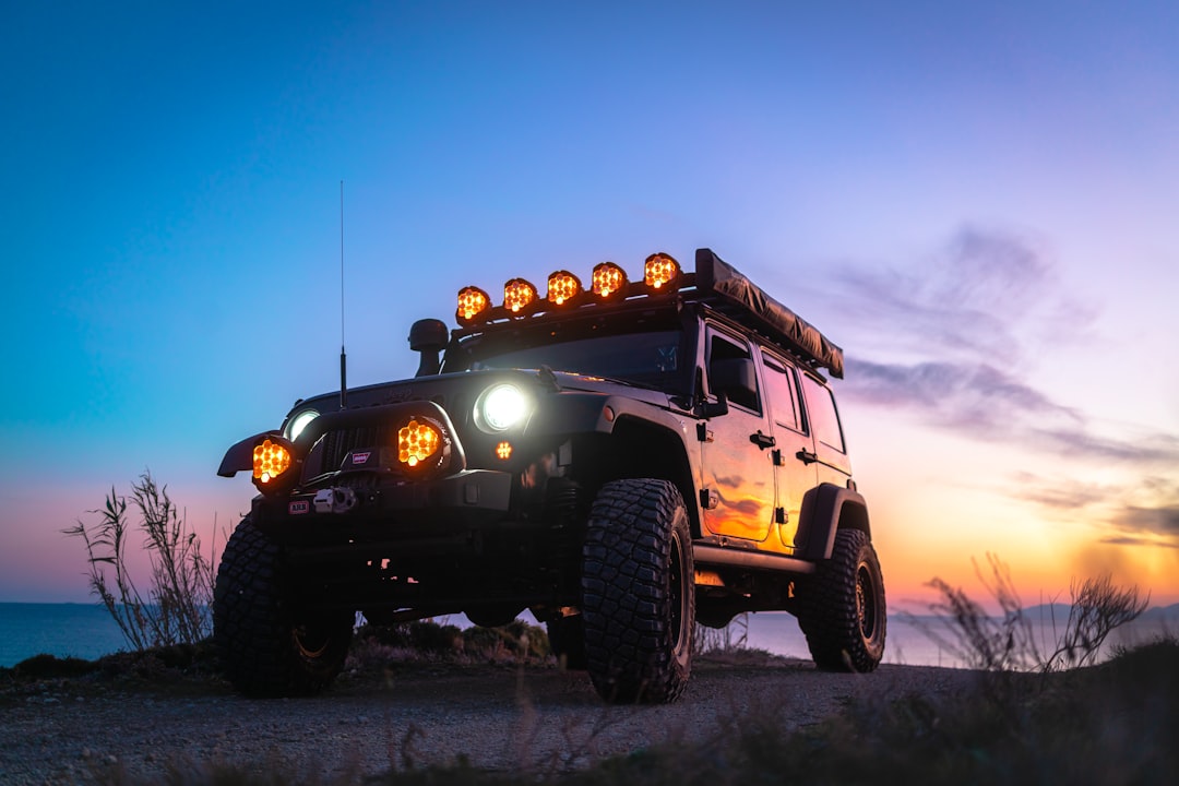 Overland vehicle with rooftop tent at sunset